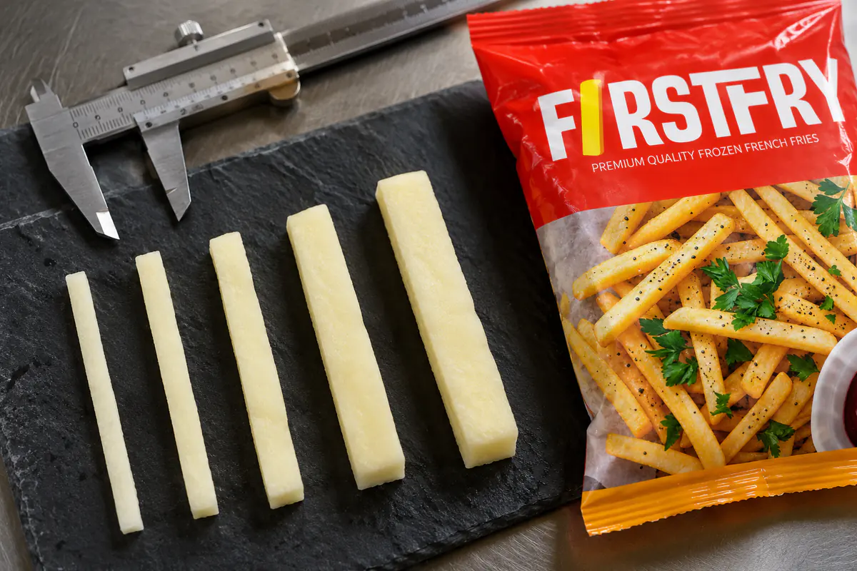 Five potato strips from thin to thick beside a caliper and a FirstFry pack